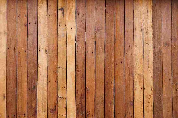 Vertical cedar fence boards installed tightly together, showing a finished board-on-board cedar fence surface