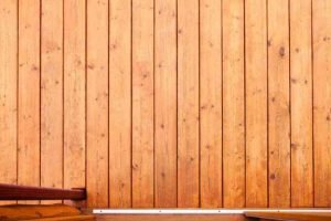 Close up view of cedar board on board fence panels installed vertically for full privacy
