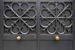 Decorative black iron double gate with detailed metalwork design